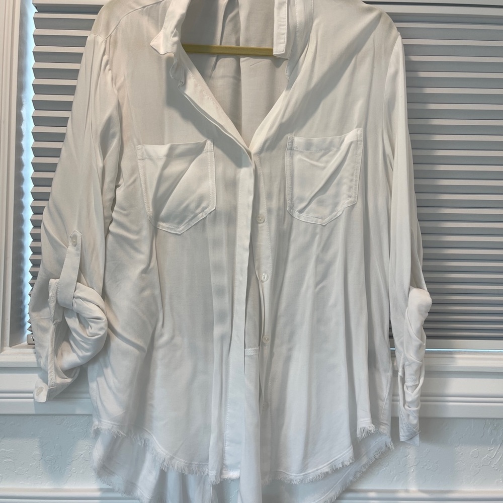 White blouse with roll up sleeve.